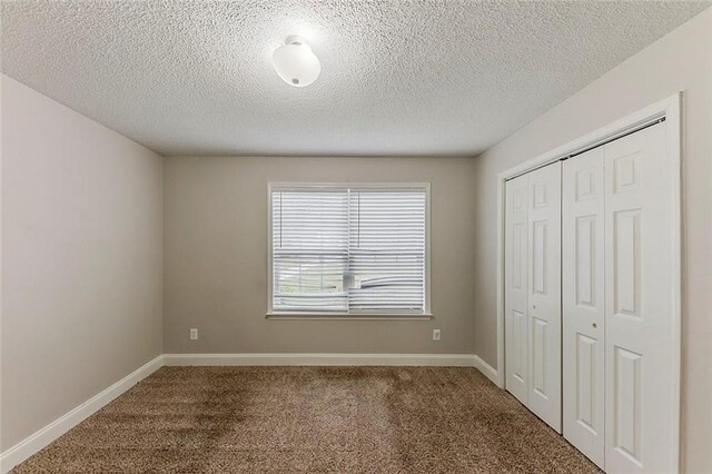 51 Legend Creek Way, Douglasville, GA 30134 - unfurnished bedroom with a raised ceiling, baseboards, carpet, and ensuite bath