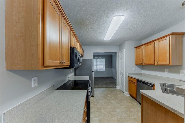 51 Legend Creek Way, Douglasville, GA 30134 - kitchen featuring brown cabinetry, a textured ceiling, a sink, light countertops, and stainless steel appliances