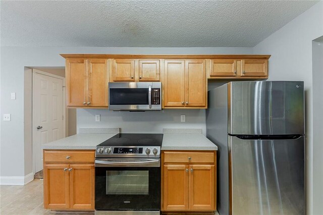 51 Legend Creek Way, Douglasville, GA 30134 - kitchen with light countertops, stainless steel appliances, a textured ceiling, and baseboards