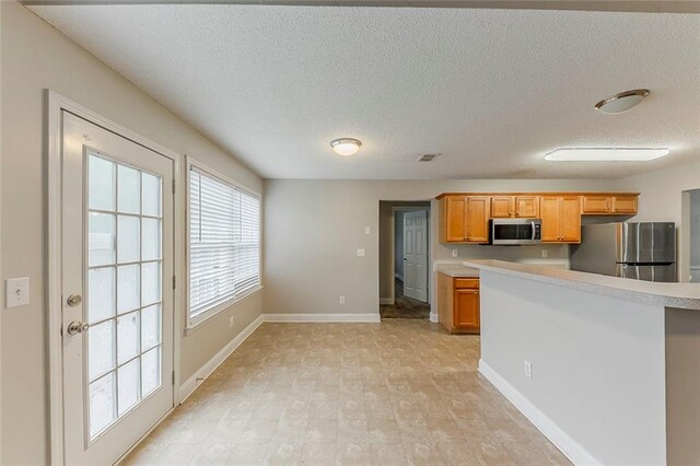 51 Legend Creek Way, Douglasville, GA 30134 - kitchen featuring light countertops, appliances with stainless steel finishes, baseboards, and a textured ceiling