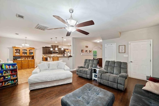 14 Oak Leaf Way, Hamilton, GA 31811 - living room with ceiling fan, wood finished floors, arched walkways, and a chandelier