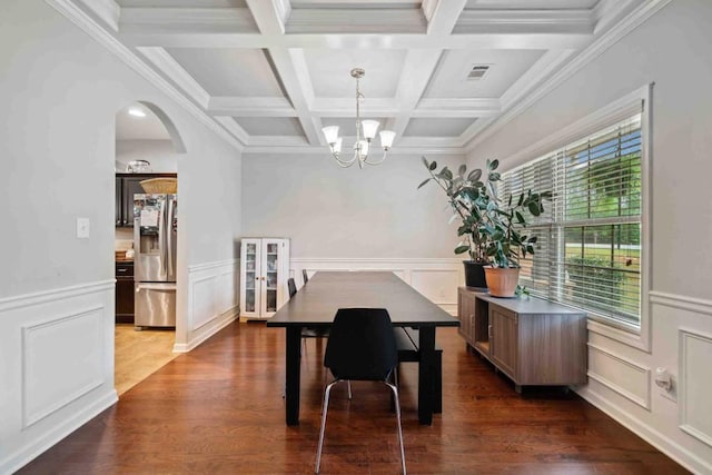 14 Oak Leaf Way, Hamilton, GA 31811 - dining space with beam ceiling, coffered ceiling, a chandelier, arched walkways, and dark wood finished floors