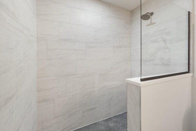 bathroom with a tile shower