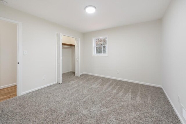 unfurnished bedroom featuring carpet flooring and a closet