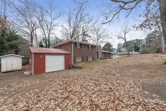 view of home's exterior with a shed and a garage