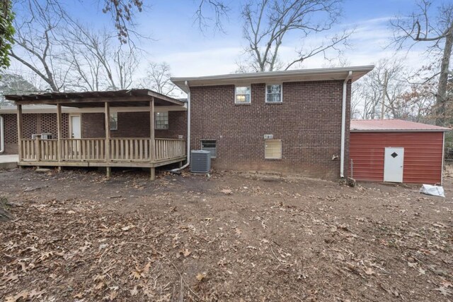 back of house featuring a wooden deck and central AC unit