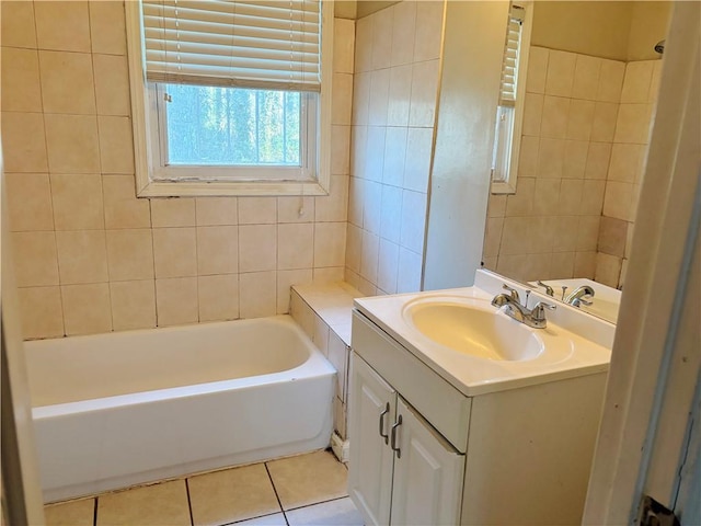 full bathroom with a bathing tub, vanity, and tile patterned floors