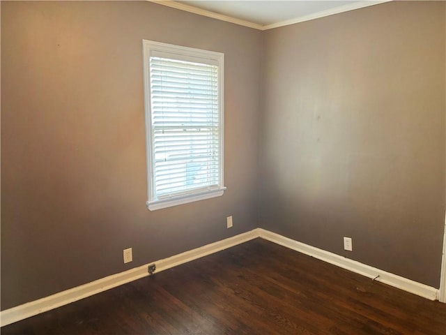 unfurnished room with ornamental molding, dark wood-type flooring, and baseboards