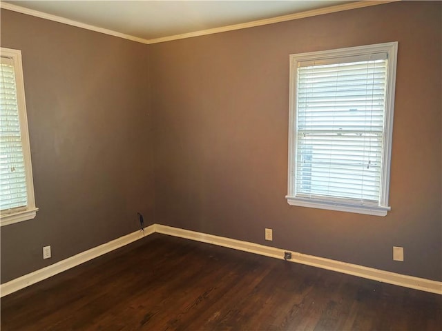 unfurnished room with crown molding, dark wood-type flooring, and baseboards