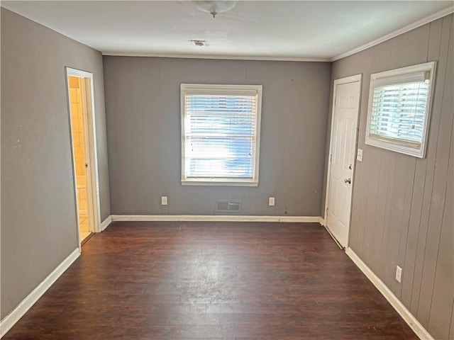 interior space with dark wood-style flooring, visible vents, and baseboards