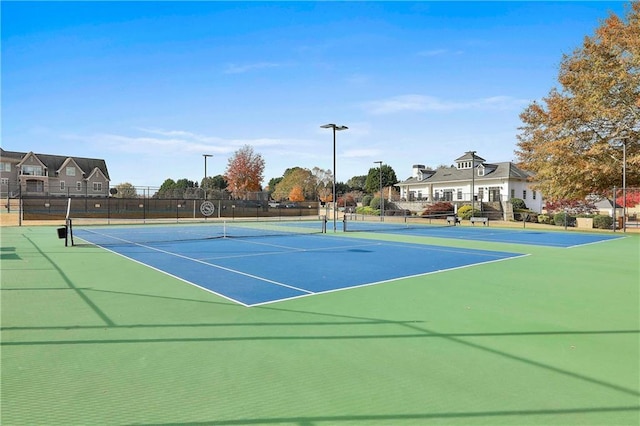 view of tennis court with fence