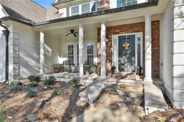view of exterior entry with a porch, roof with shingles, and ceiling fan