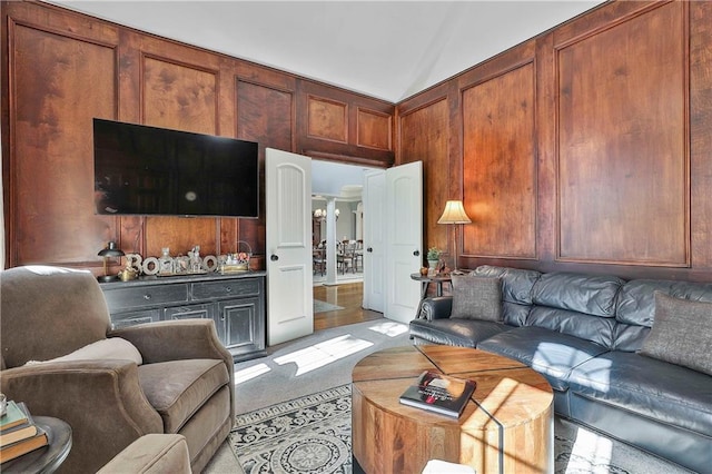 living area with light colored carpet and vaulted ceiling