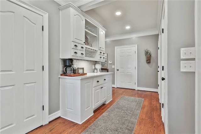 kitchen featuring open shelves, crown molding, decorative backsplash, baseboards, and white cabinetry
