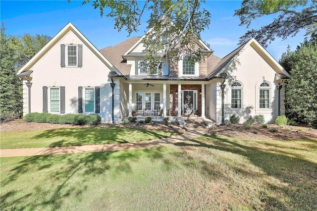 traditional home with a porch, stucco siding, and a front lawn