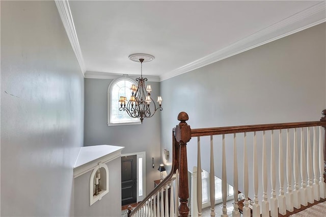 staircase with a chandelier and ornamental molding
