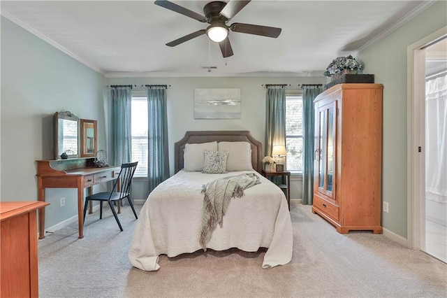 bedroom with light colored carpet, multiple windows, baseboards, and crown molding