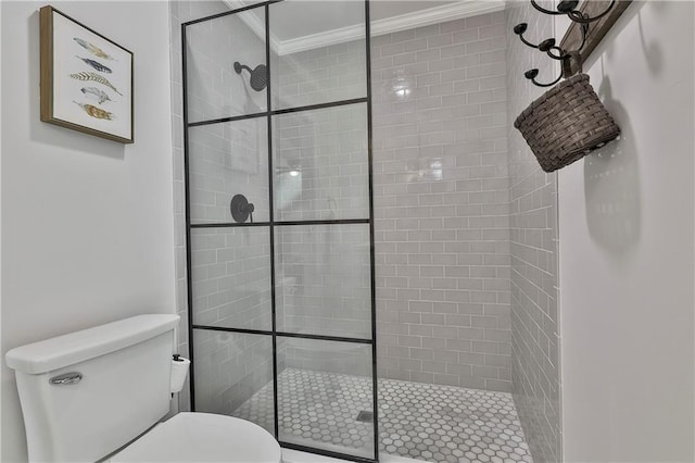 bathroom with crown molding, a stall shower, and toilet