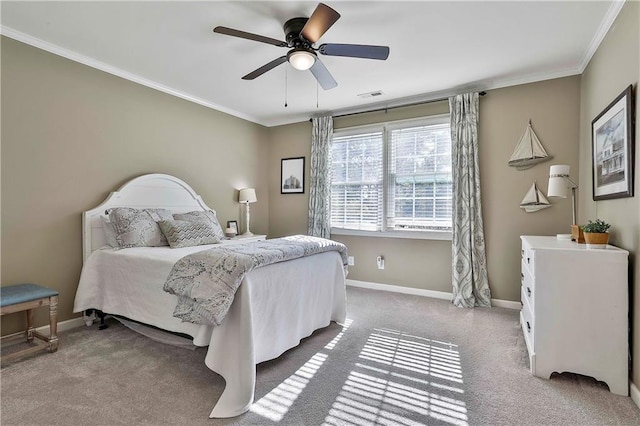 carpeted bedroom featuring ornamental molding, baseboards, and ceiling fan