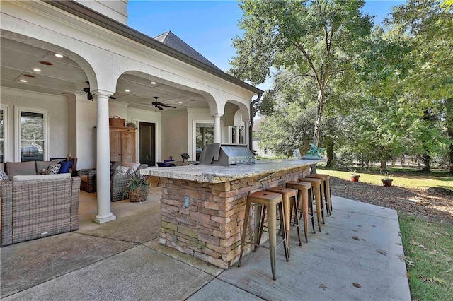 view of patio with grilling area, area for grilling, ceiling fan, and an outdoor hangout area