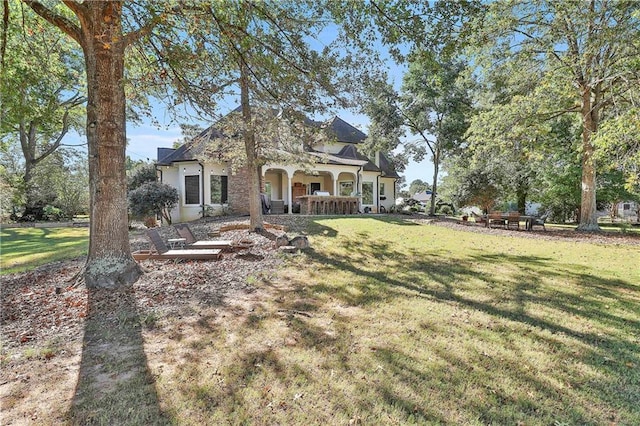 view of front of property featuring a front yard, a porch, and stucco siding