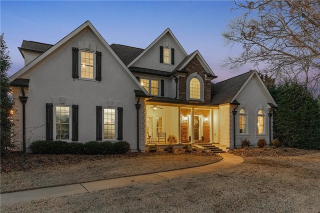 view of front of property featuring covered porch and stucco siding