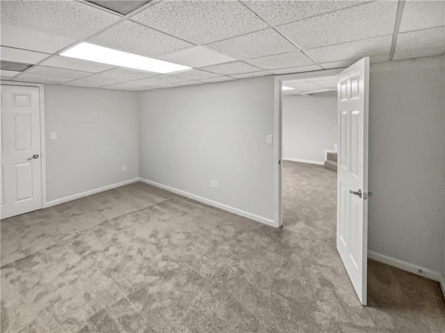 basement with carpet floors and a paneled ceiling