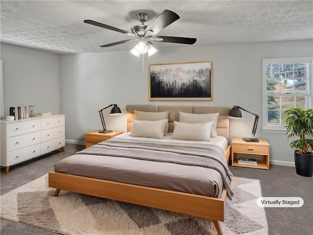 carpeted bedroom featuring a textured ceiling and ceiling fan