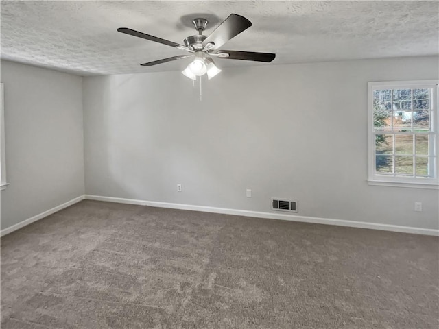 unfurnished room with ceiling fan, carpet flooring, and a textured ceiling