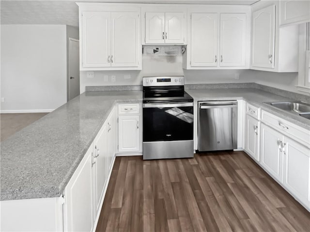 kitchen featuring dark wood-type flooring, white cabinetry, kitchen peninsula, stainless steel appliances, and exhaust hood