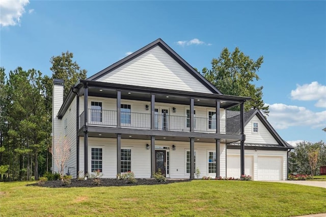 view of front facade with a garage, a front yard, a balcony, and covered porch