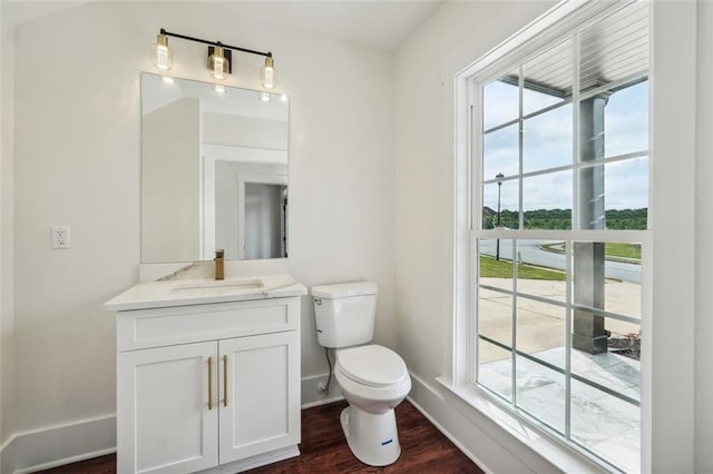 bathroom featuring hardwood / wood-style flooring, vanity, and toilet