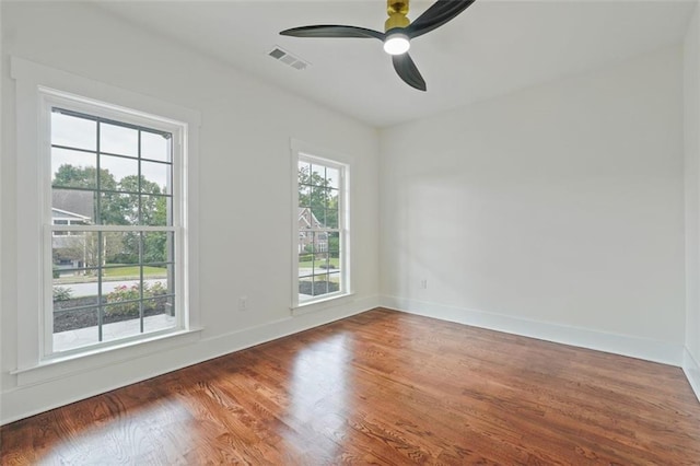 unfurnished room featuring ceiling fan and dark hardwood / wood-style floors