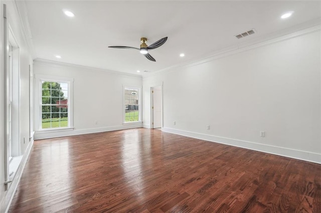 spare room featuring dark hardwood / wood-style flooring, crown molding, and ceiling fan