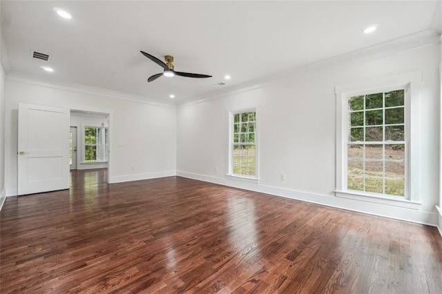 spare room featuring ornamental molding, dark hardwood / wood-style floors, and a wealth of natural light