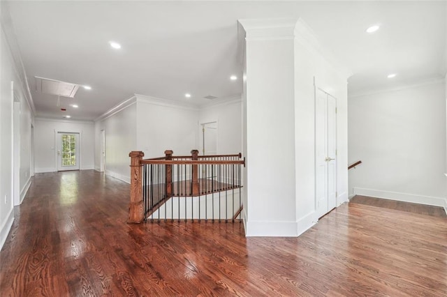 hall with hardwood / wood-style flooring and crown molding