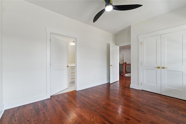 unfurnished bedroom featuring dark wood-type flooring, a closet, and ceiling fan