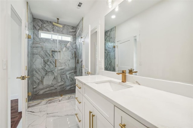 bathroom featuring an enclosed shower and vanity