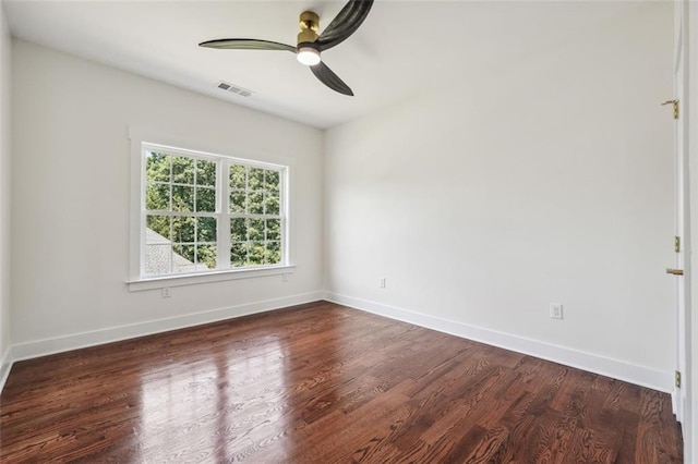 empty room featuring ceiling fan and dark hardwood / wood-style flooring