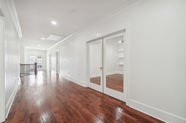 empty room with crown molding, dark hardwood / wood-style flooring, and french doors