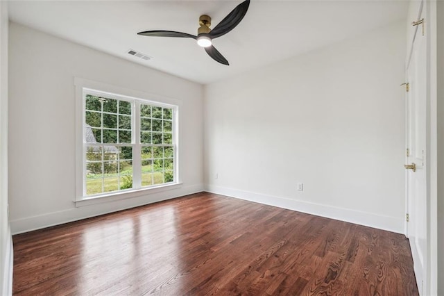 empty room featuring ceiling fan and dark hardwood / wood-style flooring