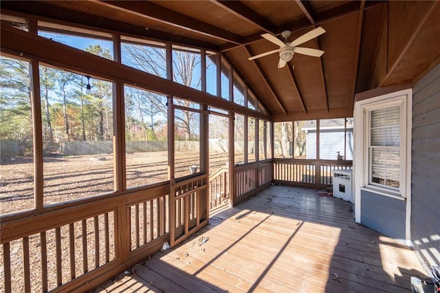 unfurnished sunroom featuring lofted ceiling with beams, ceiling fan, wood ceiling, and a wealth of natural light