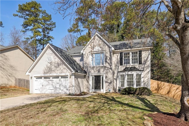 view of front of home featuring a front lawn, concrete driveway, fence, and an attached garage