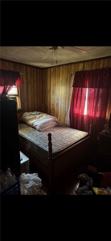 bedroom featuring wooden walls