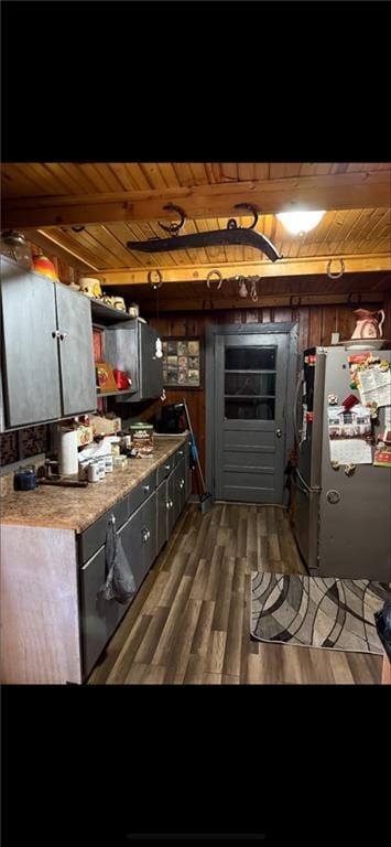 kitchen with freestanding refrigerator, wooden ceiling, and wood finished floors