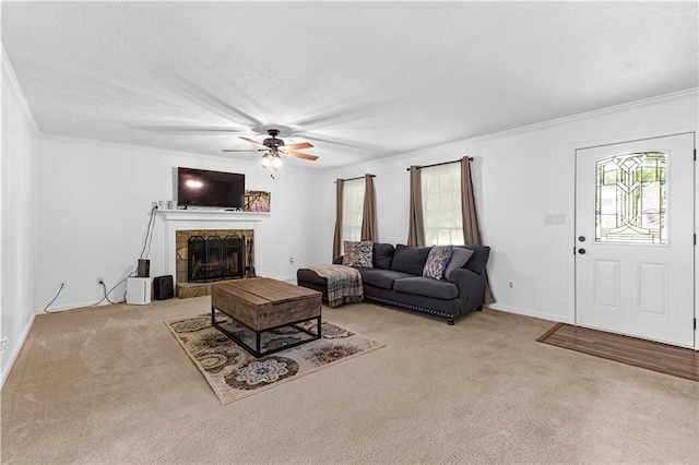 59 Cedar Way, Dallas, GA 30132 - living room with light carpet, a ceiling fan, crown molding, a stone fireplace, and baseboards