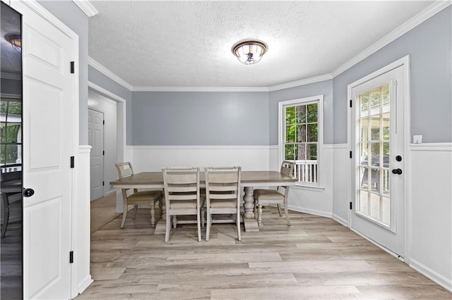 59 Cedar Way, Dallas, GA 30132 - dining space with wainscoting, wood finished floors, a textured ceiling, and crown molding