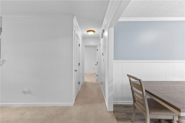 59 Cedar Way, Dallas, GA 30132 - hallway featuring a textured ceiling, ornamental molding, carpet floors, wainscoting, and baseboards