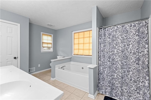 59 Cedar Way, Dallas, GA 30132 - bathroom featuring tile patterned flooring, toilet, a garden tub, a shower with curtain, and a textured ceiling