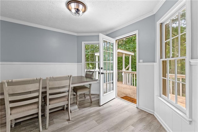 59 Cedar Way, Dallas, GA 30132 - dining space featuring a textured ceiling, wood finished floors, a decorative wall, french doors, and wainscoting